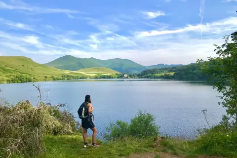 Randonneuse admirant le lac de Guéry, un magnifique itinéraire de randonnée.