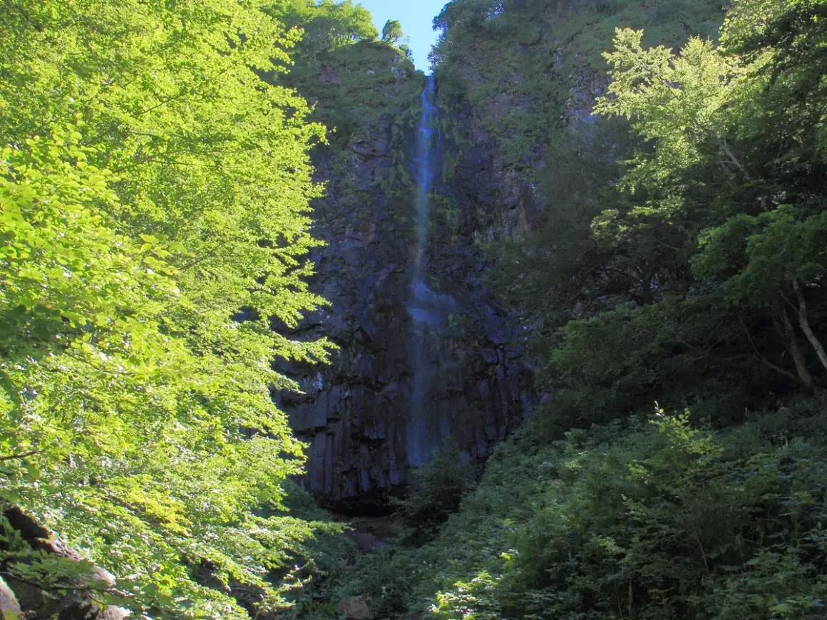 Randonnée dans la vallée de Chaudefour, la cascade de la Biche se dévoile à travers une végétation luxuriante et verdoyante.