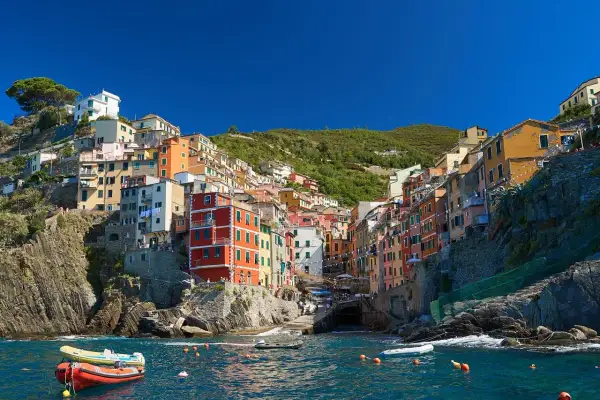 Vue colorée de Riomaggiore, un village des Cinque Terre, parfait pour un séjour de 3 jours. Bateaux dans l'eau bleue.